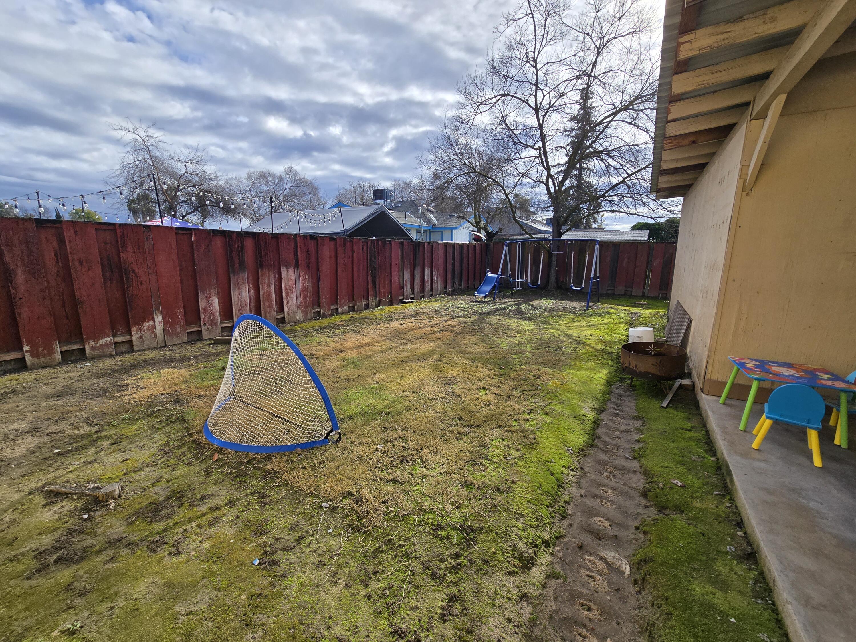 2222-2224 11th Street Reedley, CA 93654 - Photo 9 of 11 a view of a backyard with a slide