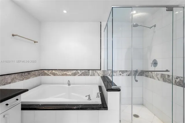 a bathroom with a bathtub and a shower