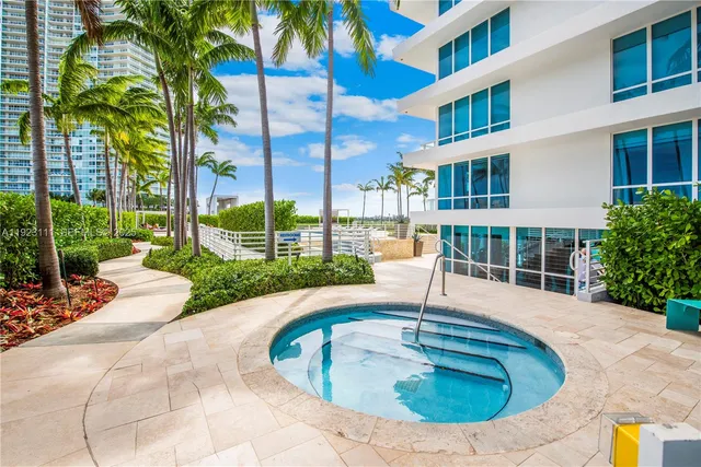 a view of swimming pool with outdoor seating and a palm tree