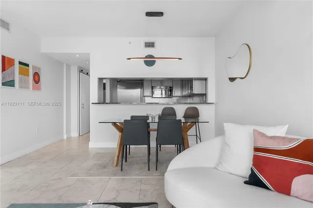 a living room with furniture a dining table and chairs