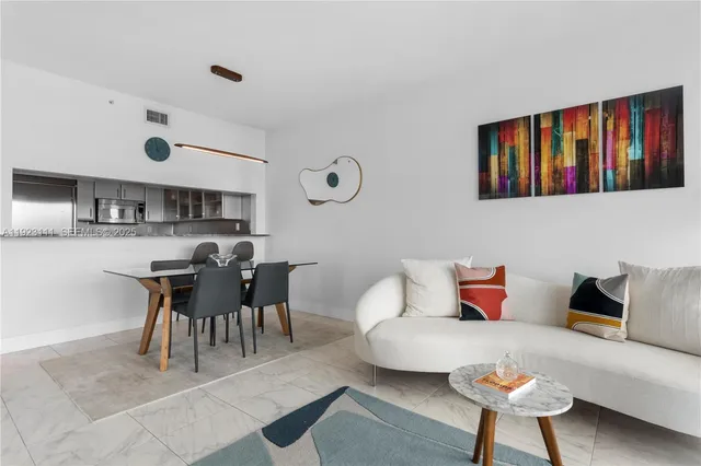 a living room with furniture a rug and a window