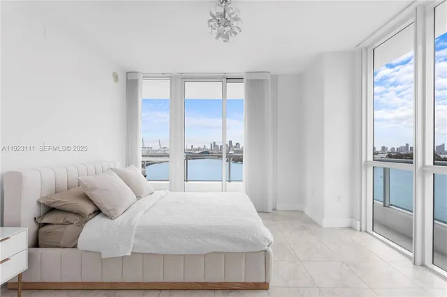 a large white bed in a white room