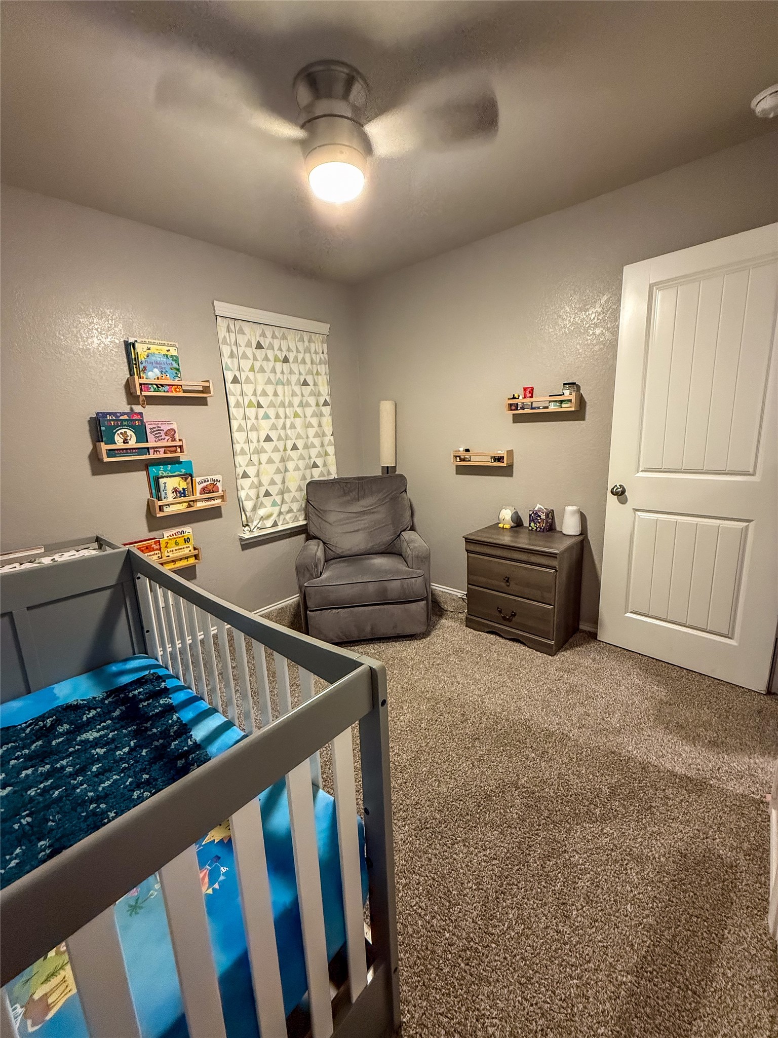 706 Zinnia Court Rosharon, TX 77583 - Photo 9 of 13 Cozy bedroom or office with neutral walls, carpeted floor, and ceiling fan.