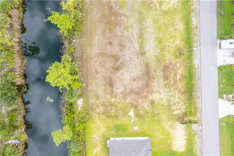 a view of a lot of flowers with of a house