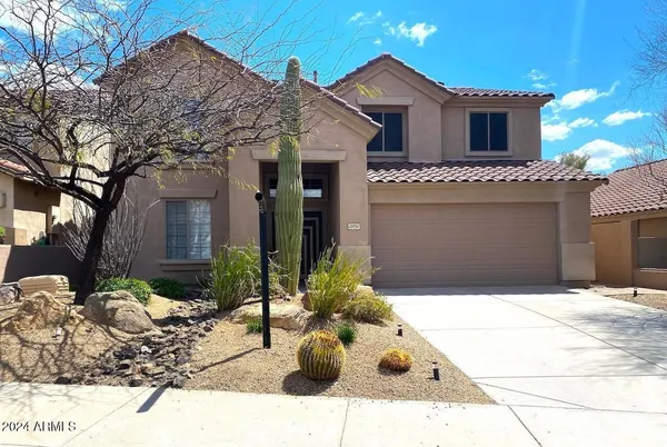 a view of a house with a bench in the patio