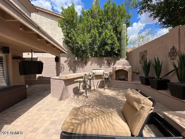a view of a patio with table and chairs potted plants with wooden floor