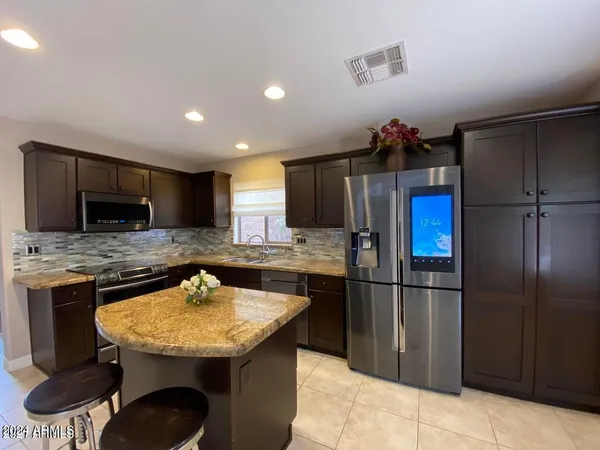 a kitchen with stainless steel appliances granite countertop a sink stove and refrigerator