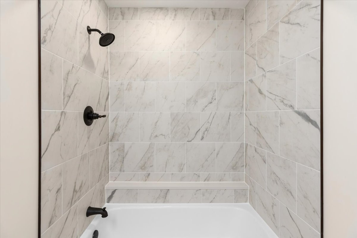 4711 Spicewood Springs Road, Unit 4222 Austin, TX 78759 - Photo 6 of 35 Indulge in this recently renovated, well-appointed bath, featuring a sleek tub and elegantly tiled shower.
