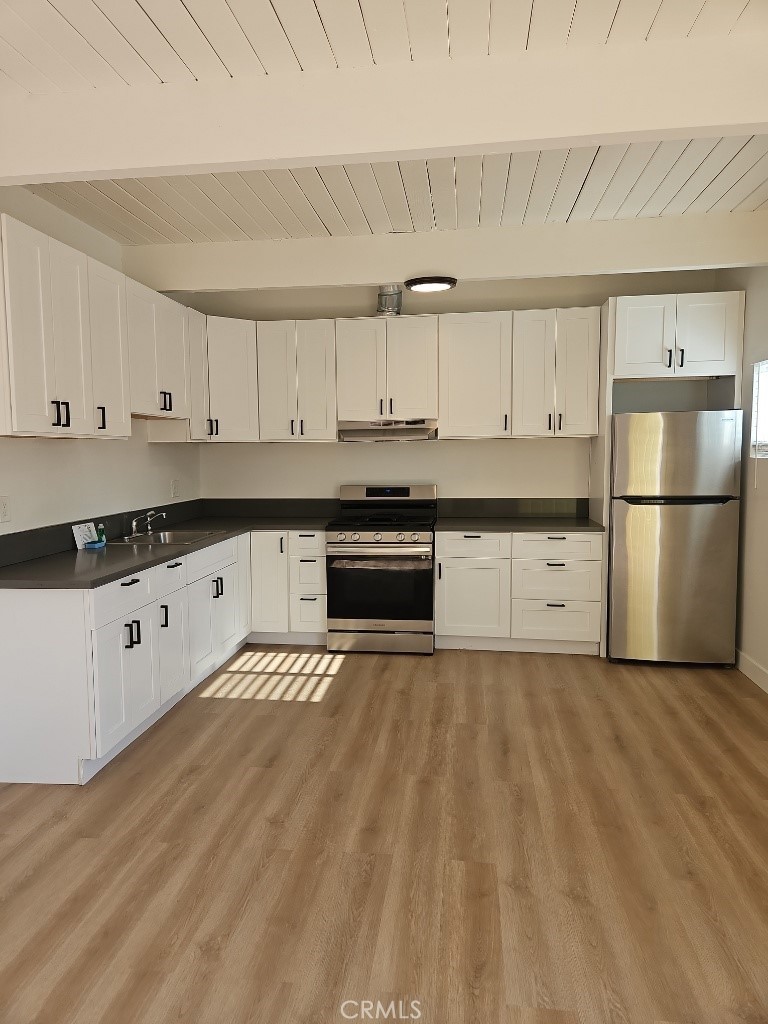 3581 Chicago Avenue Riverside, CA 92507 - Photo 2 of 5 a kitchen with stainless steel appliances granite countertop a refrigerator a stove a sink and white cabinets