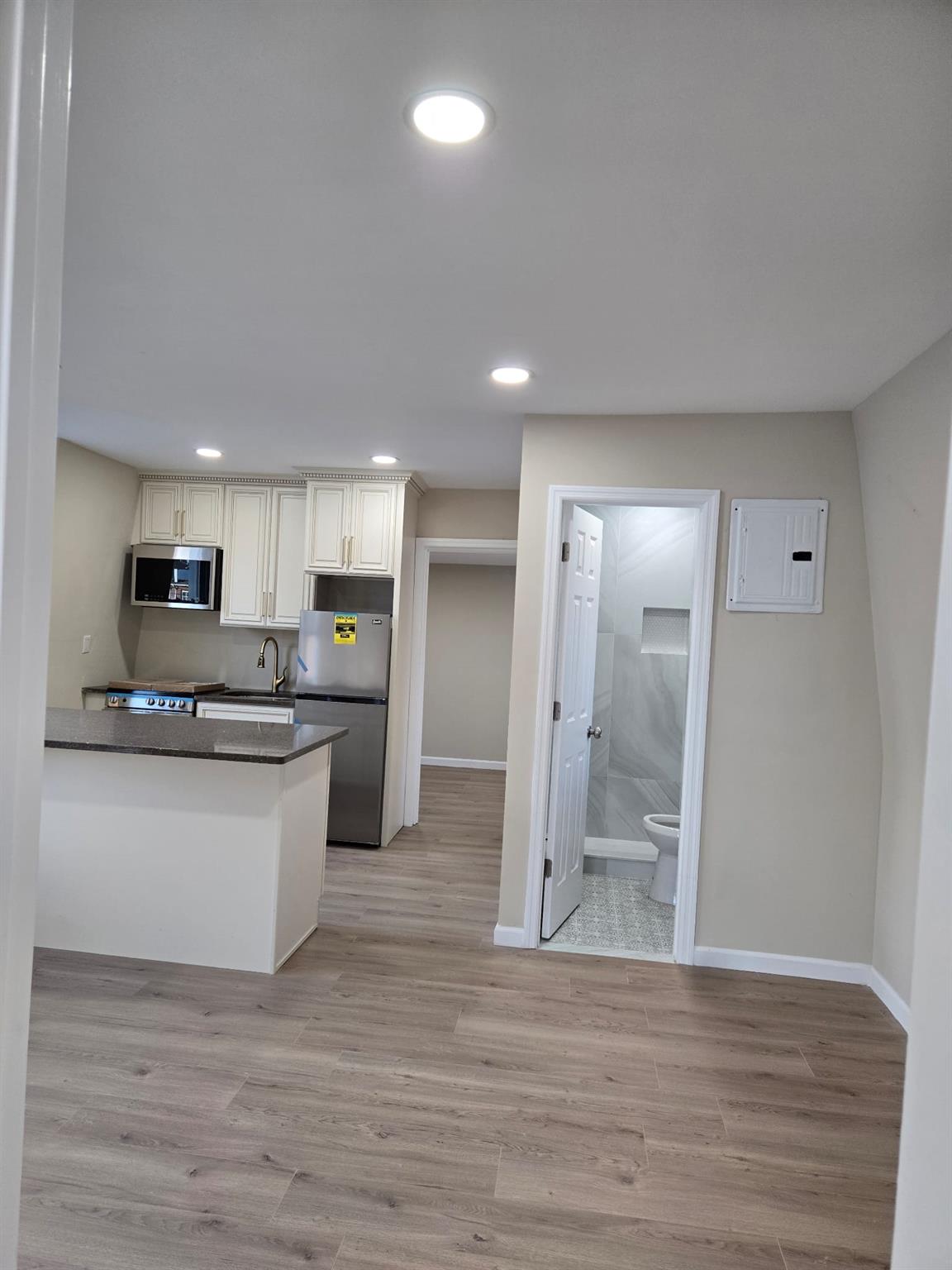 35-14 109th Street Queens, NY 11368 - Photo 20 of 38 Kitchen featuring recessed lighting, stainless steel appliances, dark countertops, electric panel, and baseboards