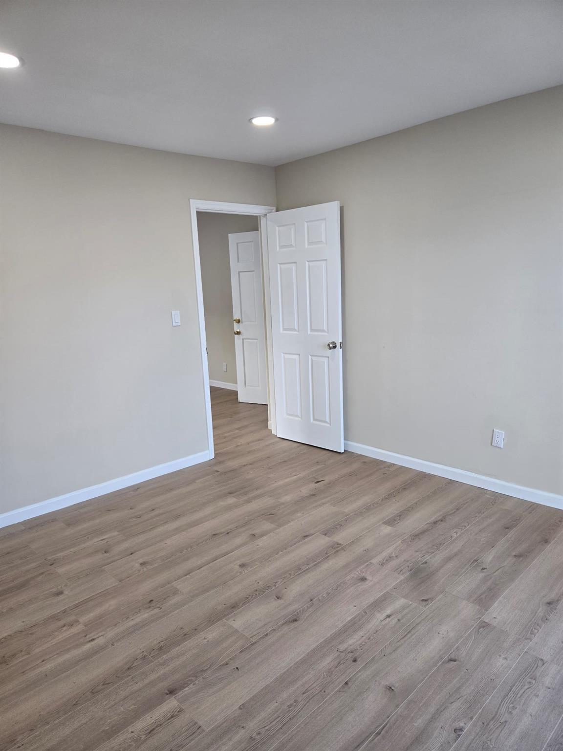 35-14 109th Street Queens, NY 11368 - Photo 24 of 38 Spare room with baseboards, wood finished floors, and recessed lighting