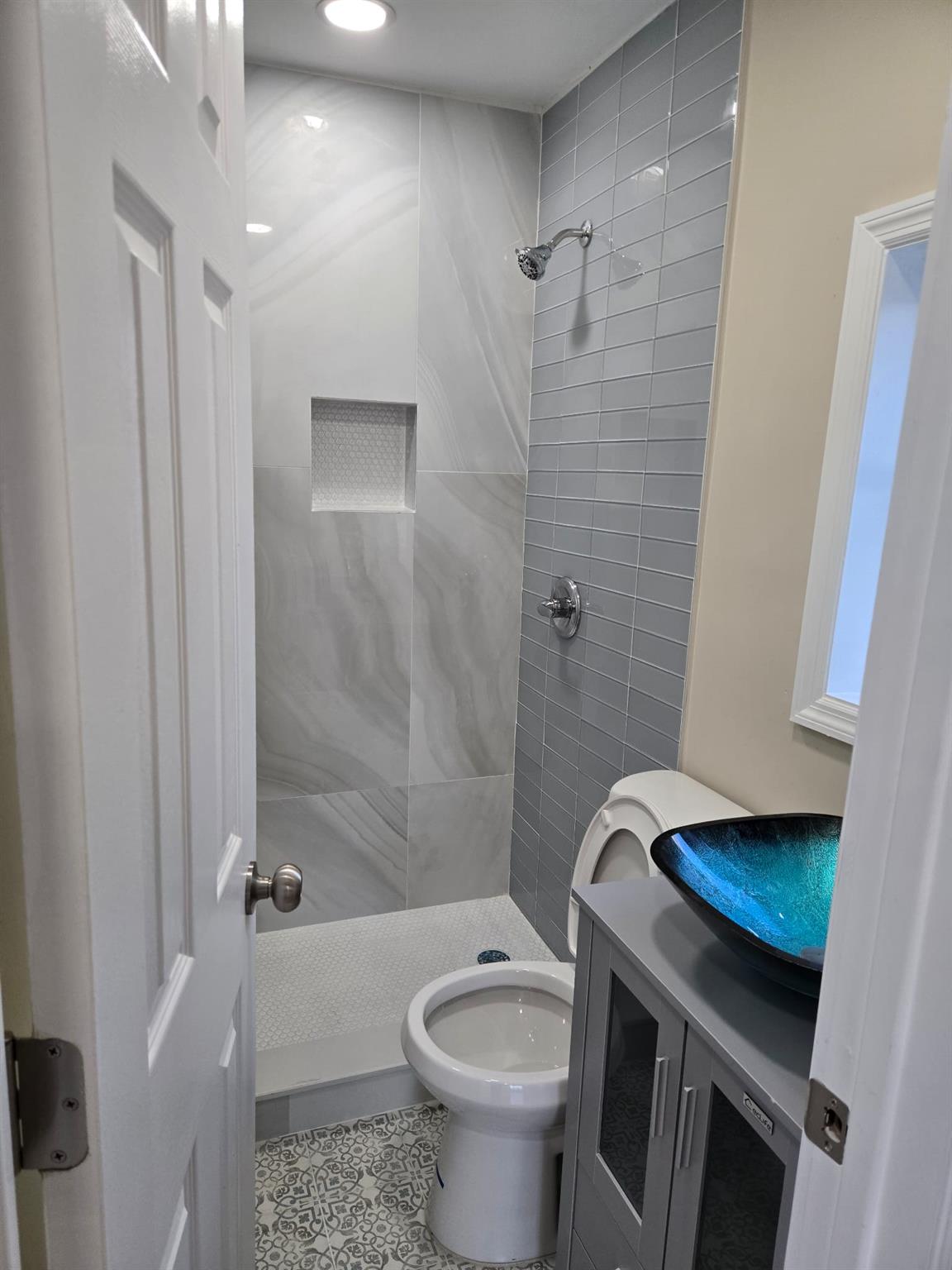 35-14 109th Street Queens, NY 11368 - Photo 25 of 38 Full bath with tile patterned flooring, toilet, vanity, and a stall shower