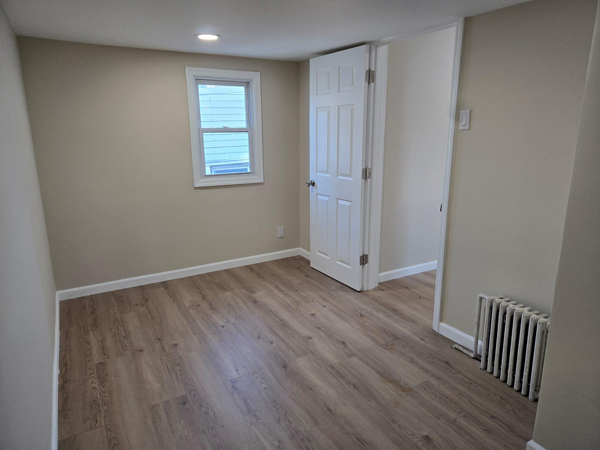 35-14 109th Street Queens, NY 11368 - Photo 27 of 38 Empty room featuring baseboards, wood finished floors, recessed lighting, and radiator