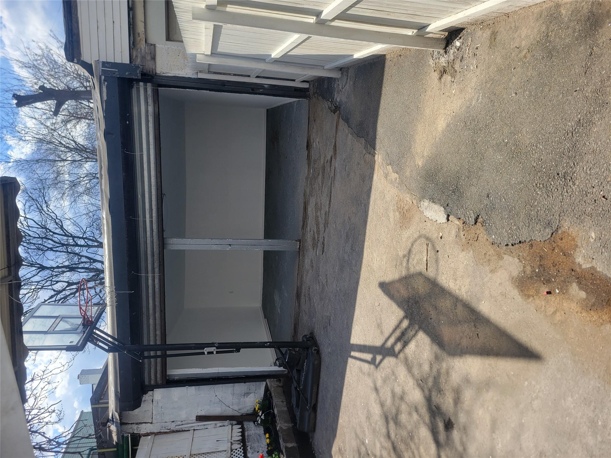 35-14 109th Street Queens, NY 11368 - Photo 36 of 38 View of car parking featuring fence and a carport