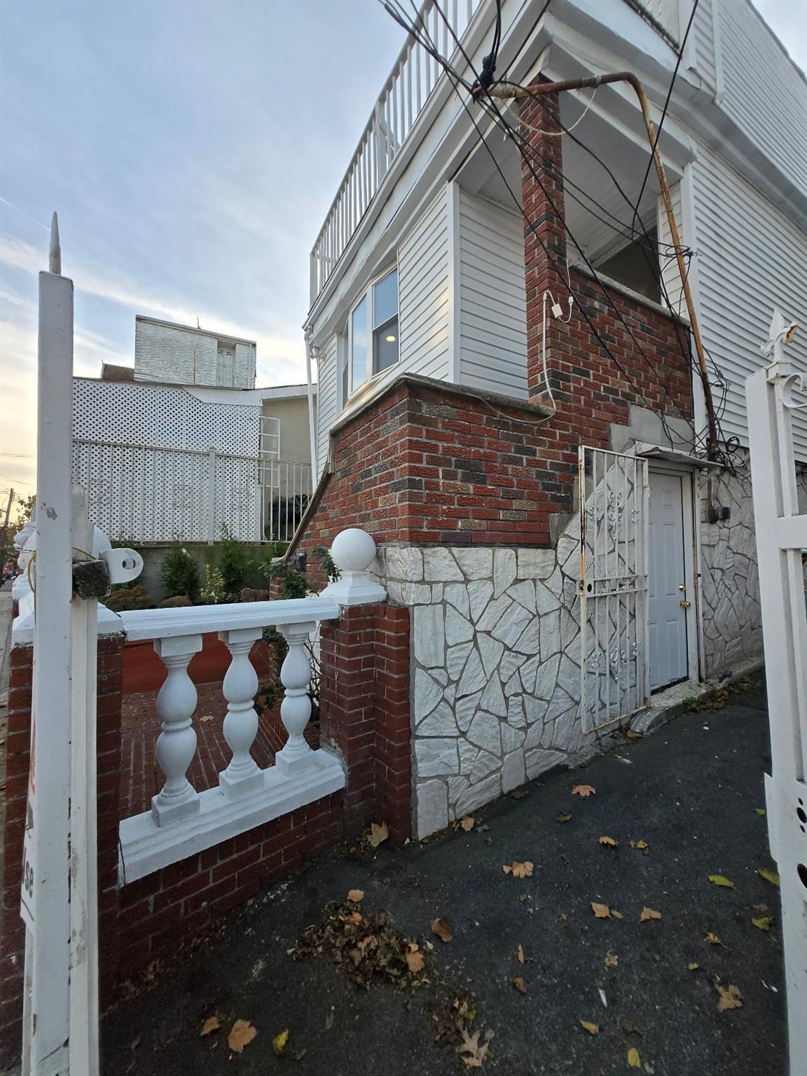 35-14 109th Street Queens, NY 11368 - Photo 4 of 38 View of side of property with brick siding and stone siding