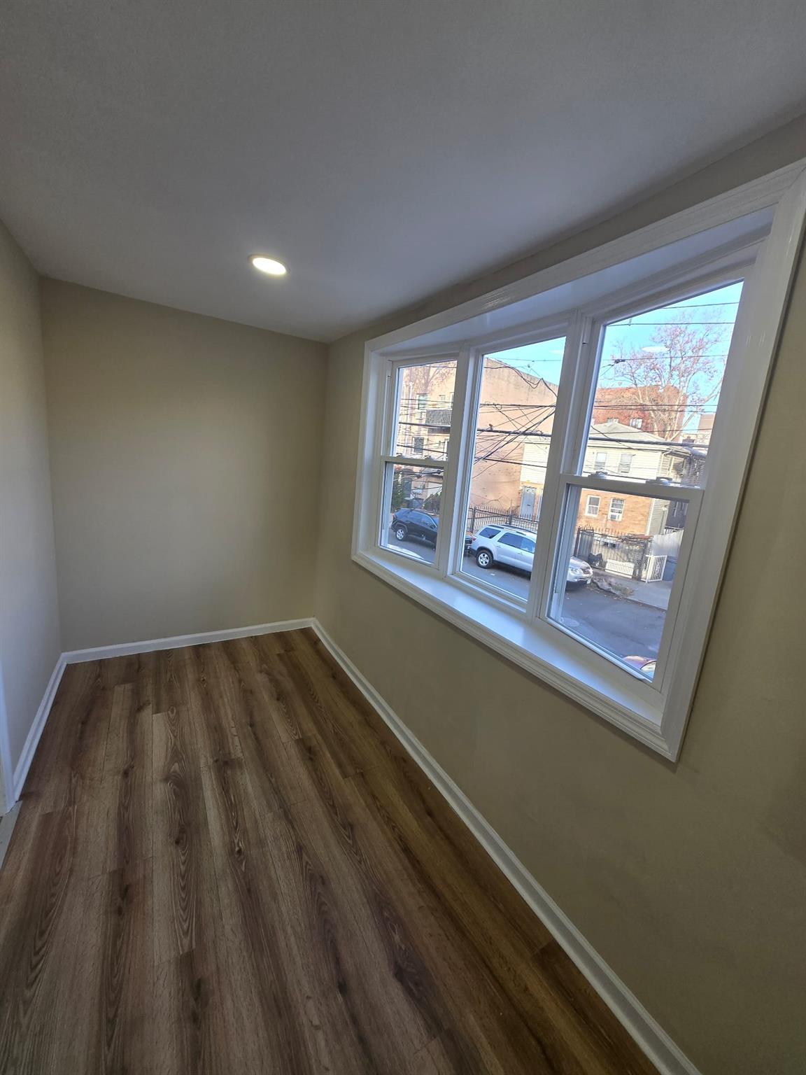 35-14 109th Street Queens, NY 11368 - Photo 10 of 38 Unfurnished room featuring baseboards, recessed lighting, and dark wood finished floors