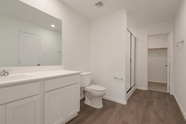 a bathroom with a sink toilet and a mirror