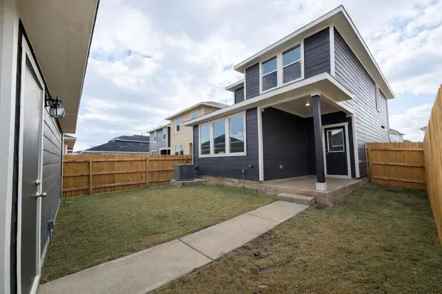 a view of a house with a backyard