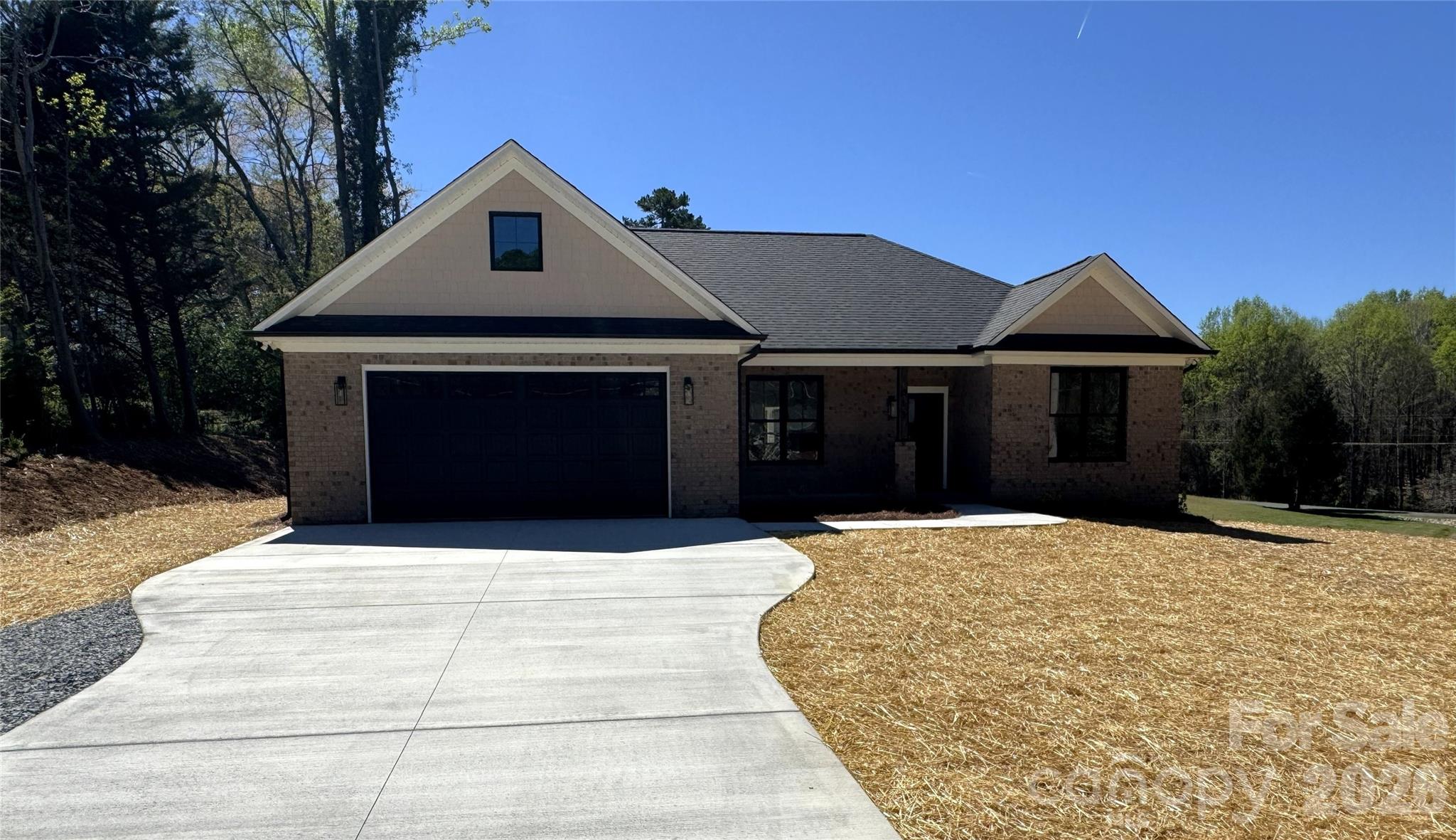 613 Bethany Road Albemarle, NC 28001 - Photo 1 of 26 a front view of a house with a yard and garage