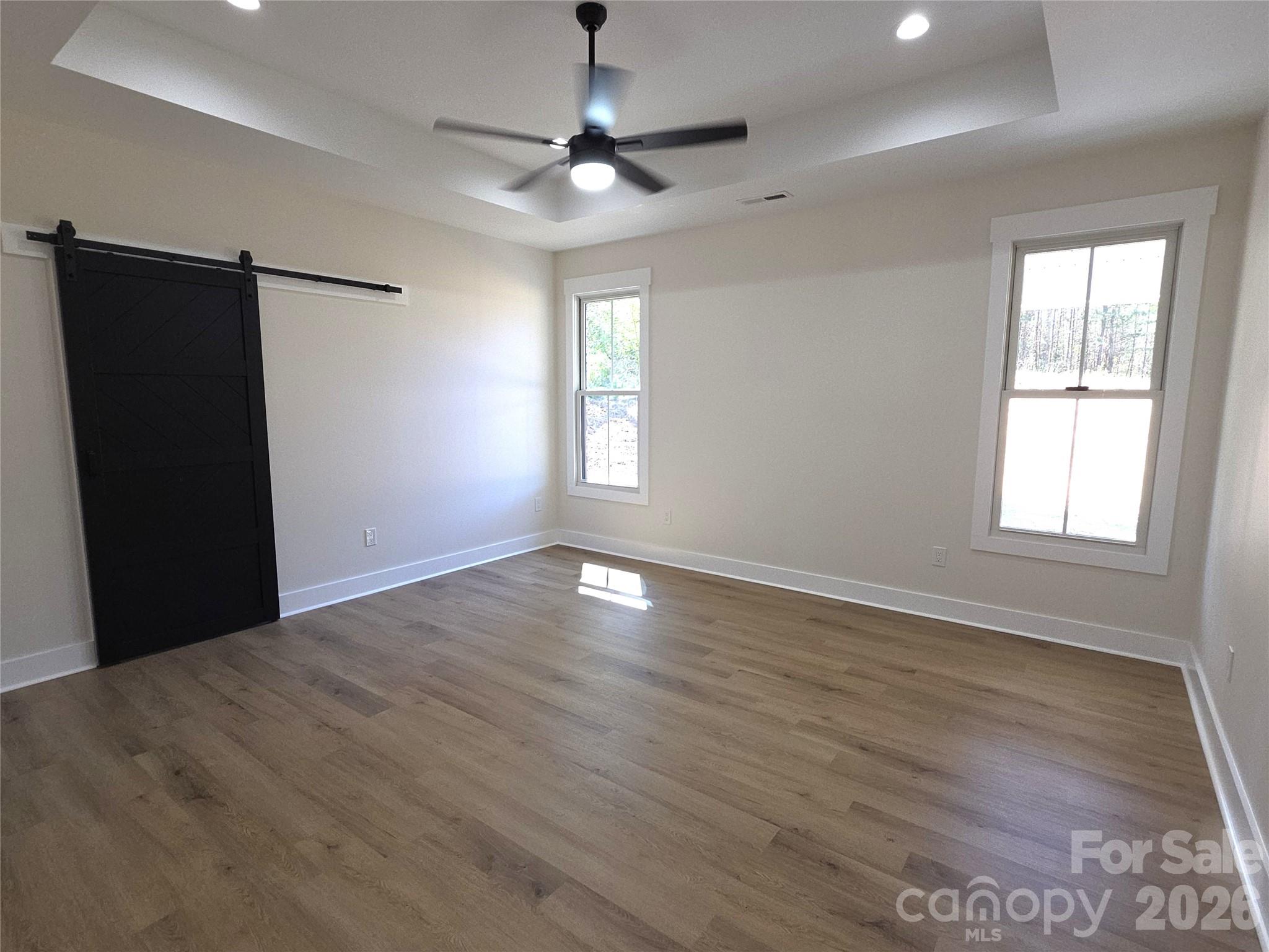 613 Bethany Road Albemarle, NC 28001 - Photo 11 of 26 a view of an empty room with wooden floor and a window