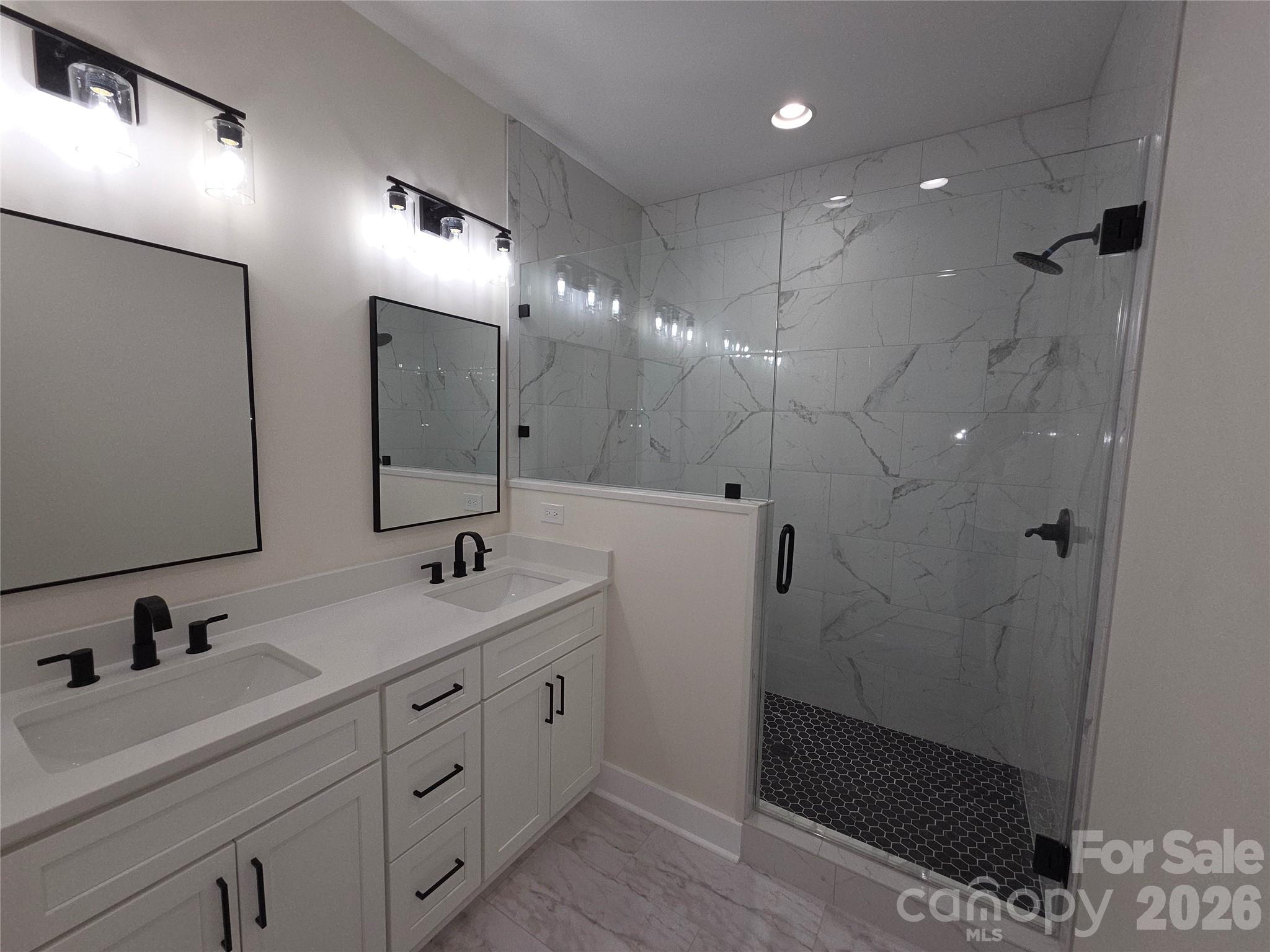 613 Bethany Road Albemarle, NC 28001 - Photo 13 of 26 a bathroom with a double vanity sink mirror and shower