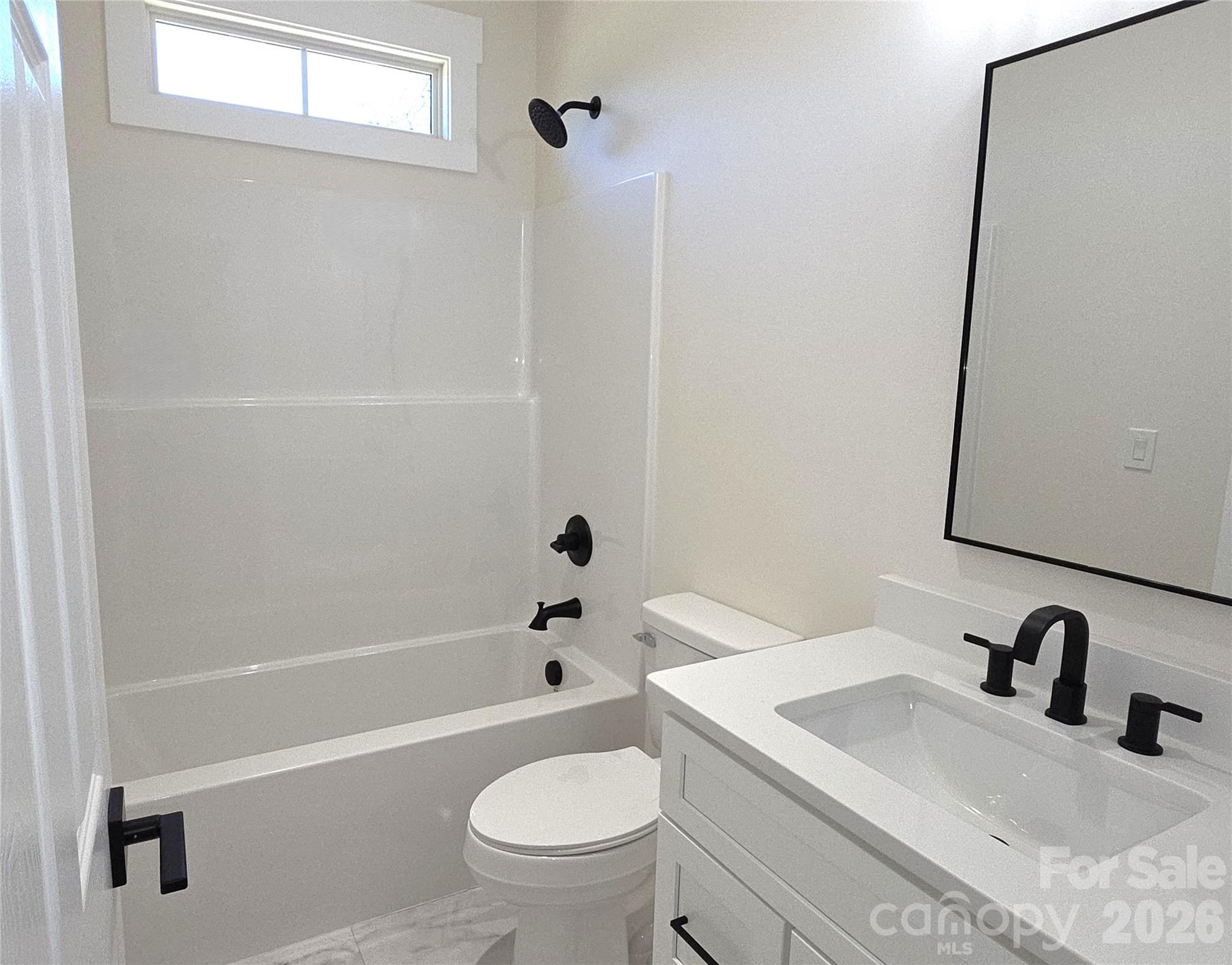613 Bethany Road Albemarle, NC 28001 - Photo 16 of 26 a bathroom with a sink a toilet and shower