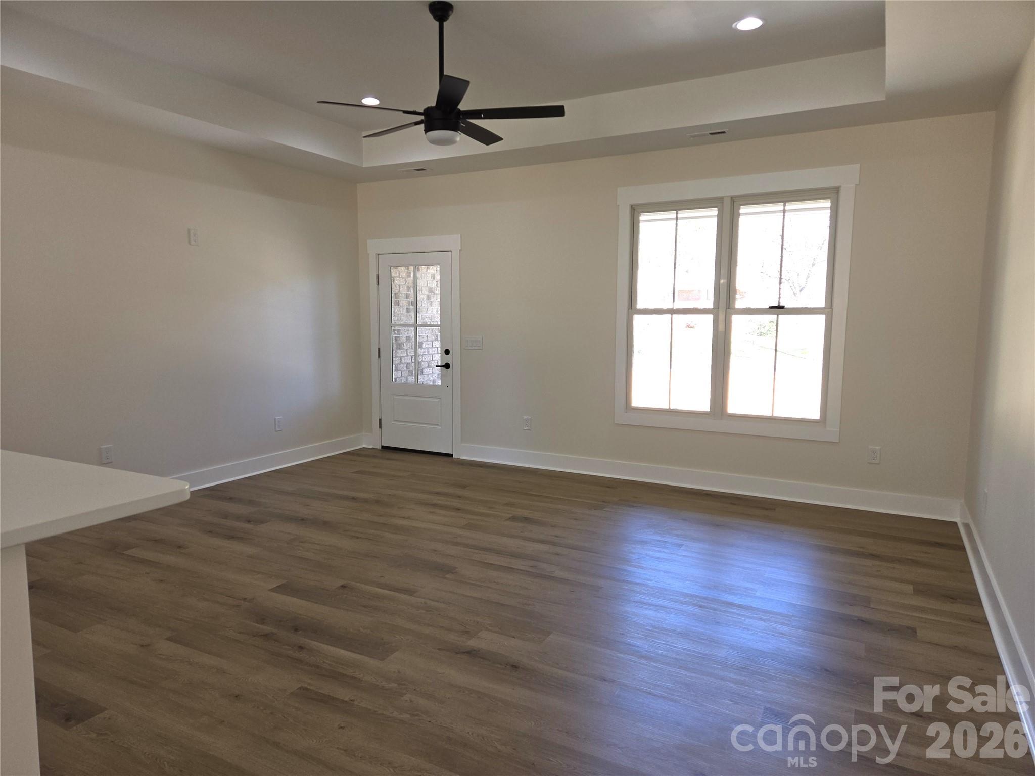 613 Bethany Road Albemarle, NC 28001 - Photo 2 of 26 a view of an empty room with wooden floor and a window