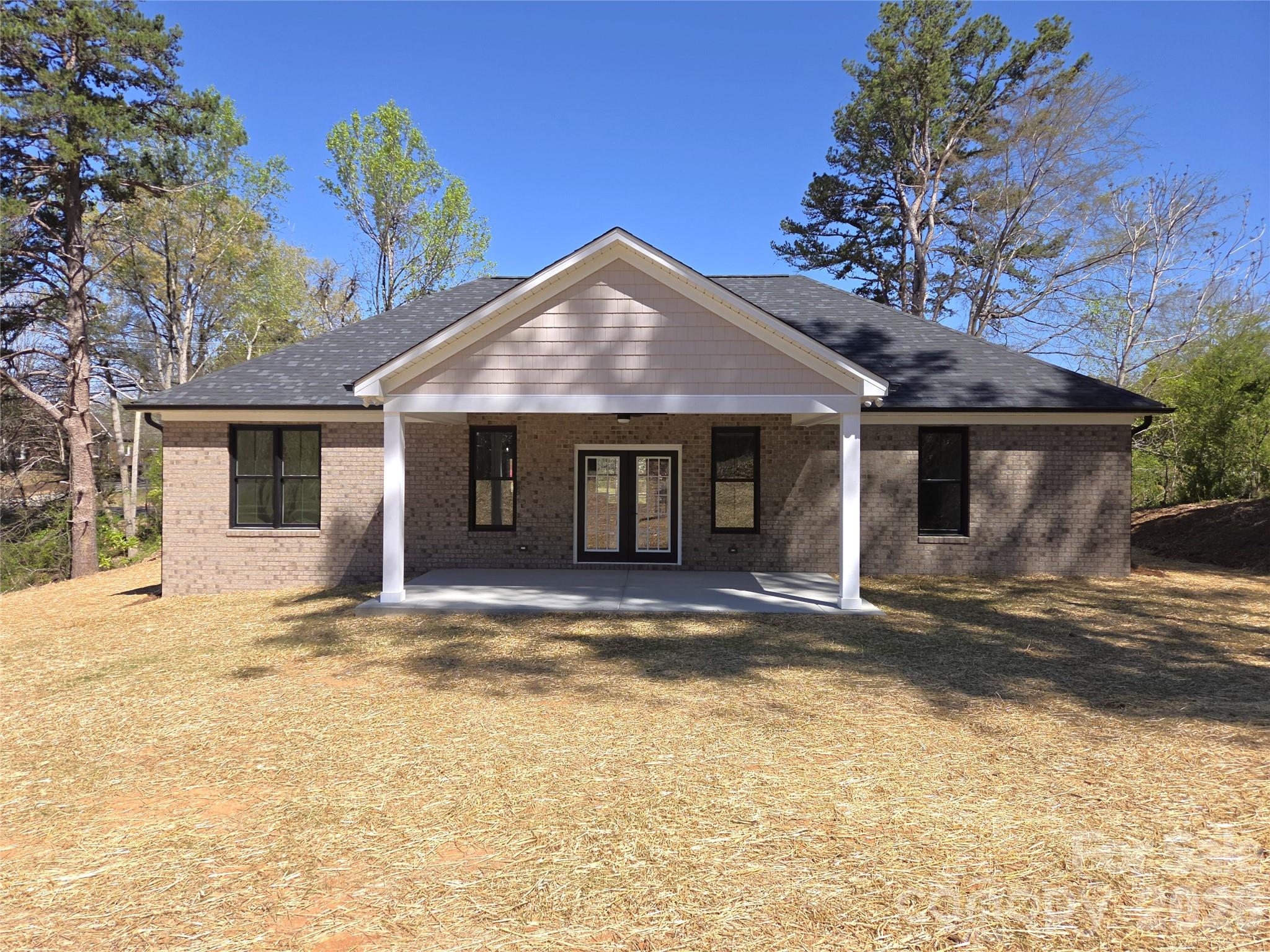 613 Bethany Road Albemarle, NC 28001 - Photo 23 of 26 a front view of a house with a garden and yard