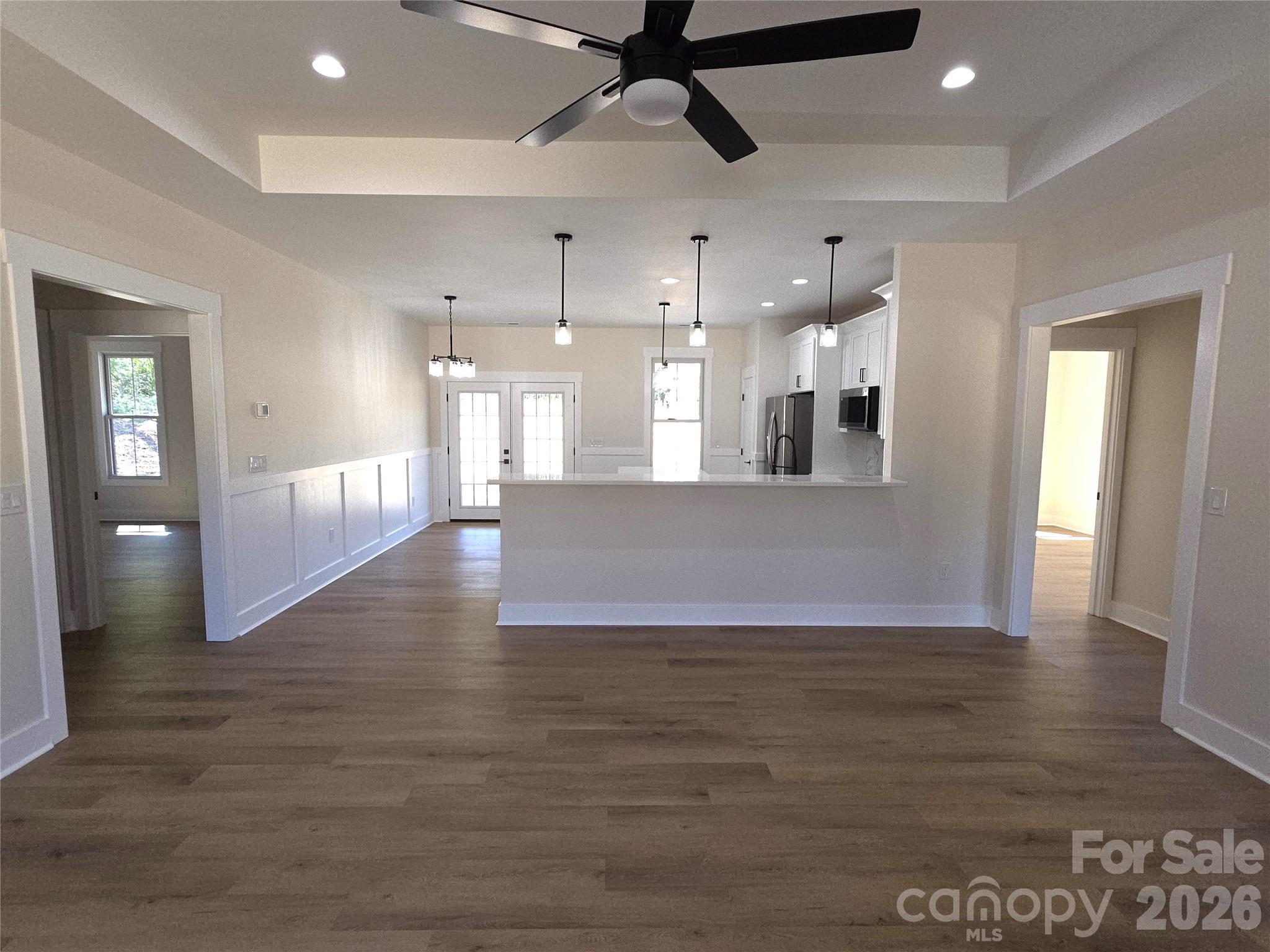 613 Bethany Road Albemarle, NC 28001 - Photo 5 of 26 a view of a big room with wooden floor and a kitchen