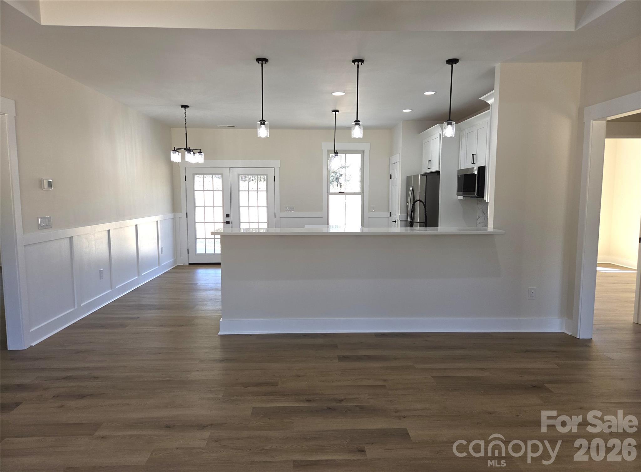 613 Bethany Road Albemarle, NC 28001 - Photo 6 of 26 a view of an empty room with wooden floor and a window