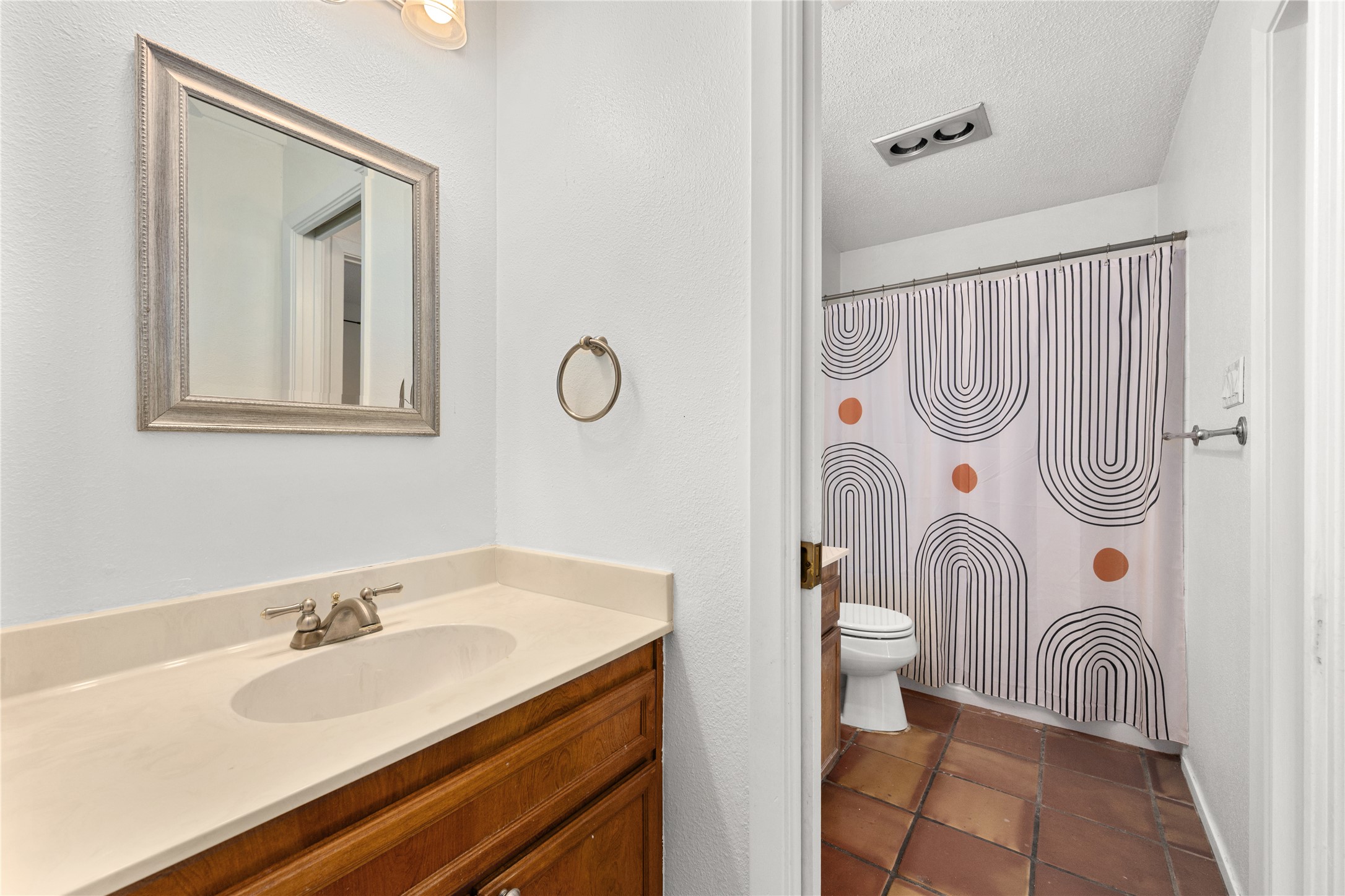 1501 Barton Springs Road, Unit 118 Austin, TX 78704 - Photo 15 of 23 The full bathroom features double vanities and a tub/shower combo, offering both comfort and functionality.