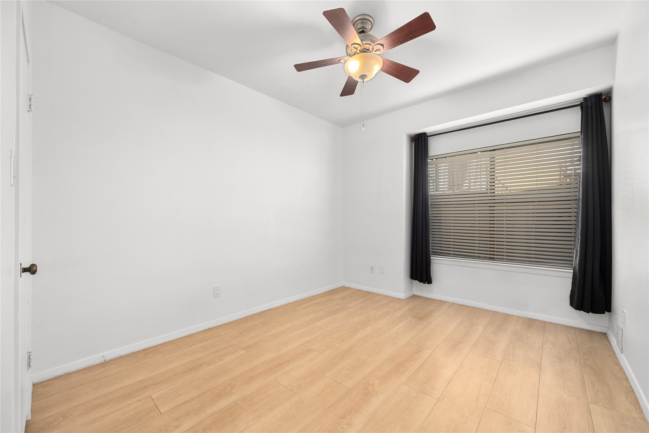1501 Barton Springs Road, Unit 118 Austin, TX 78704 - Photo 17 of 23 The guest bedroom features the same light flooring and a ceiling fan, providing comfortable and cohesive design