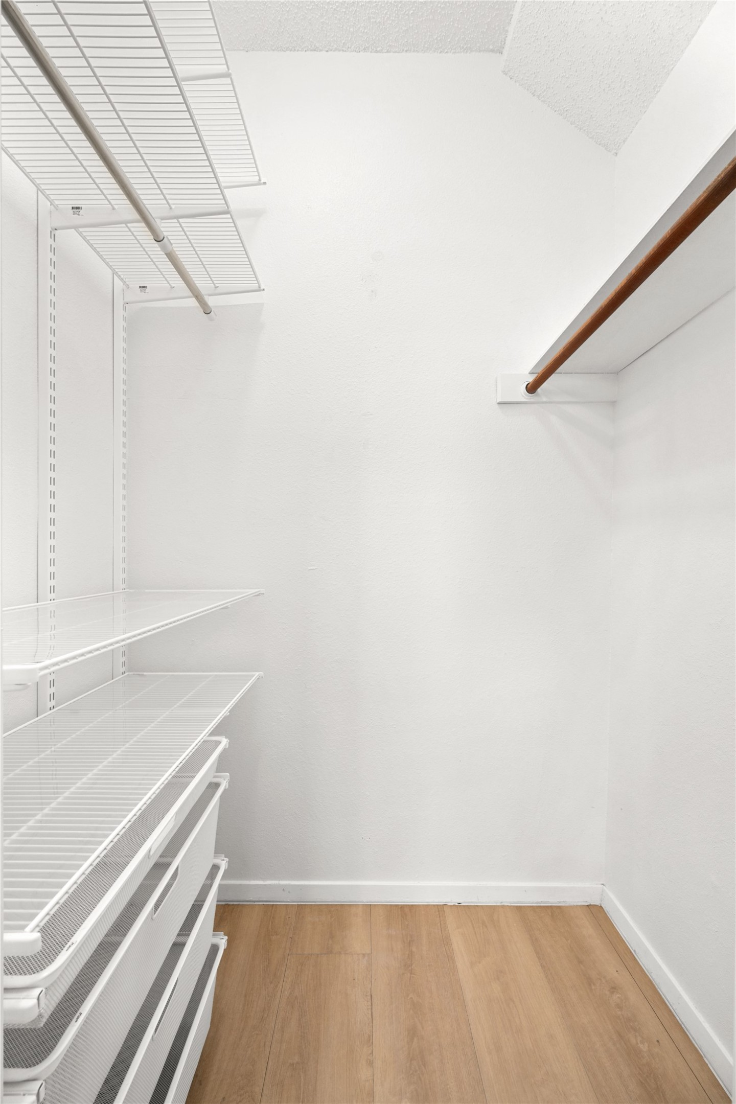 1501 Barton Springs Road, Unit 118 Austin, TX 78704 - Photo 18 of 23 Spacious closet with light wood-style flooring and Container Store Elfa custom closet systems