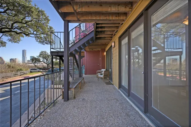 a view of a porch with wooden floor and fence
