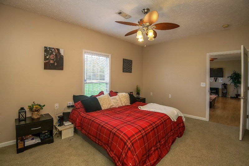 987 Boynton Valley Road Manchester, TN 37355 - Photo 15 of 38 a bedroom with a bed and a chandelier
