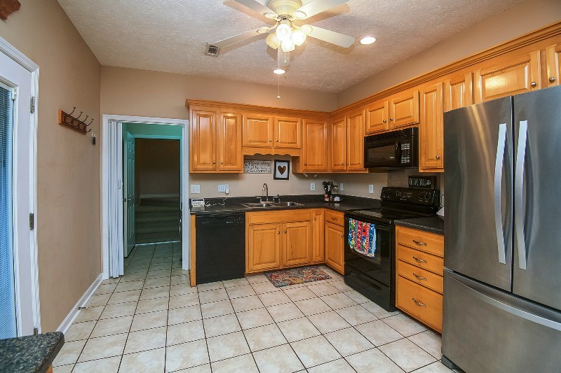 987 Boynton Valley Road Manchester, TN 37355 - Photo 9 of 38 a kitchen with stainless steel appliances granite countertop a refrigerator oven a sink dishwasher and a refrigerator