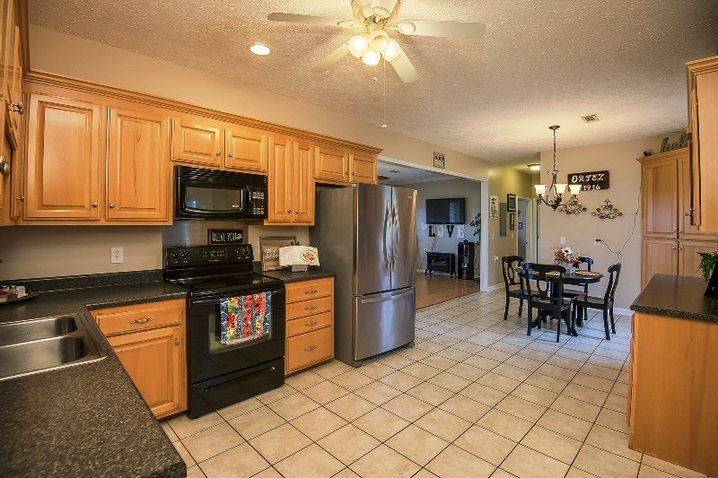 987 Boynton Valley Road Manchester, TN 37355 - Photo 10 of 38 a kitchen with stainless steel appliances granite countertop a refrigerator stove top oven and sink