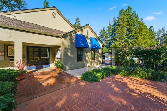 a view of house with outdoor space and sitting area