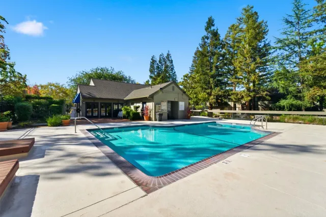an aerial view of residential houses with outdoor space and lake view