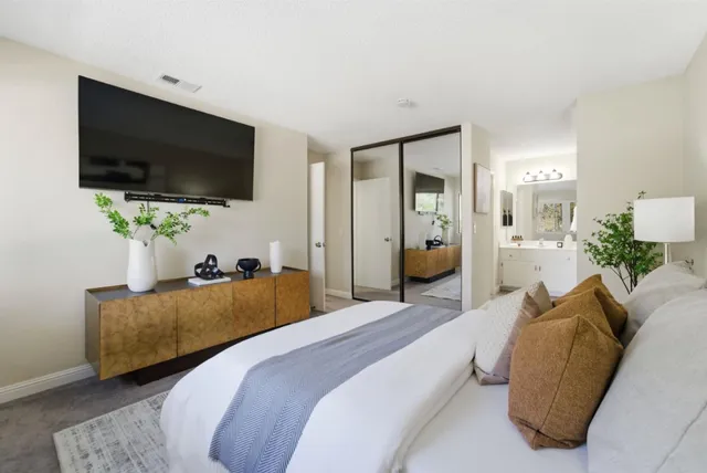 a bedroom with a bed and a flat screen tv