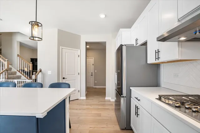 a kitchen with stainless steel appliances a sink stove and cabinets