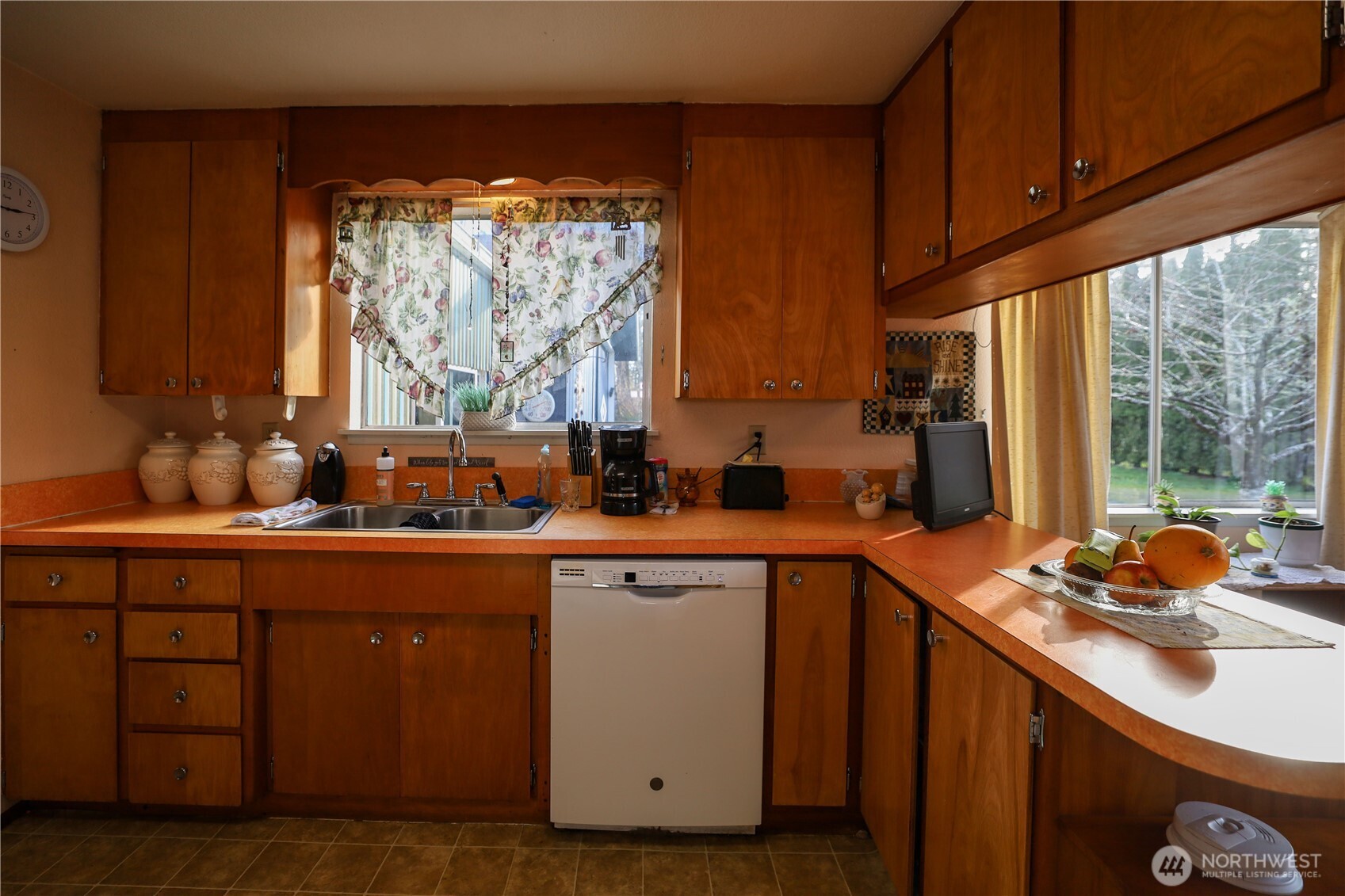 3506 SR 105 Grayland, WA 98547 - Photo 11 of 25 a kitchen with stainless steel appliances wooden cabinets a sink and a large window