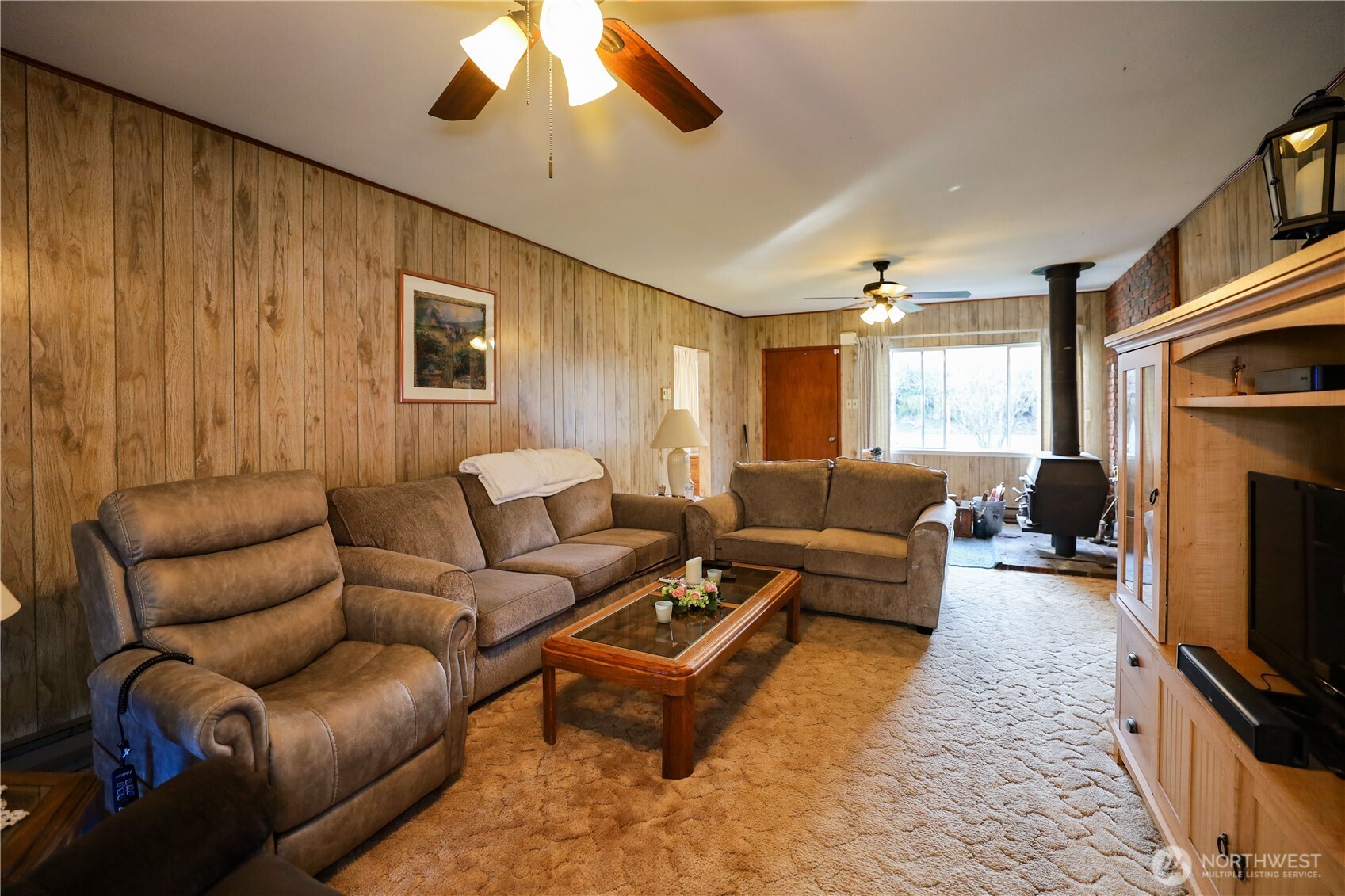 3506 SR 105 Grayland, WA 98547 - Photo 5 of 25 a living room with furniture a flat screen tv and a fireplace
