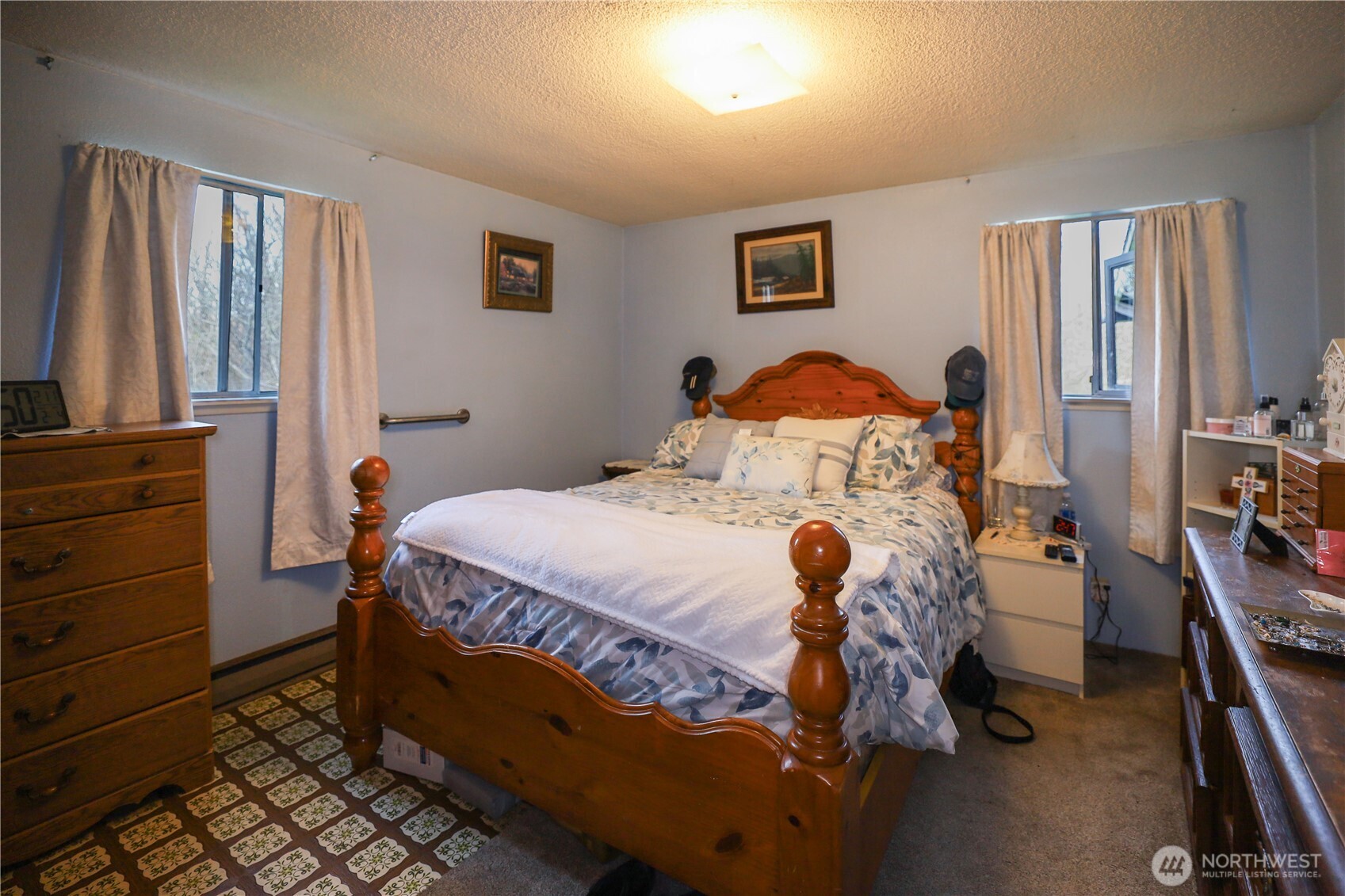 3506 SR 105 Grayland, WA 98547 - Photo 8 of 25 a bedroom with a bed and a flat tv screen on dresser