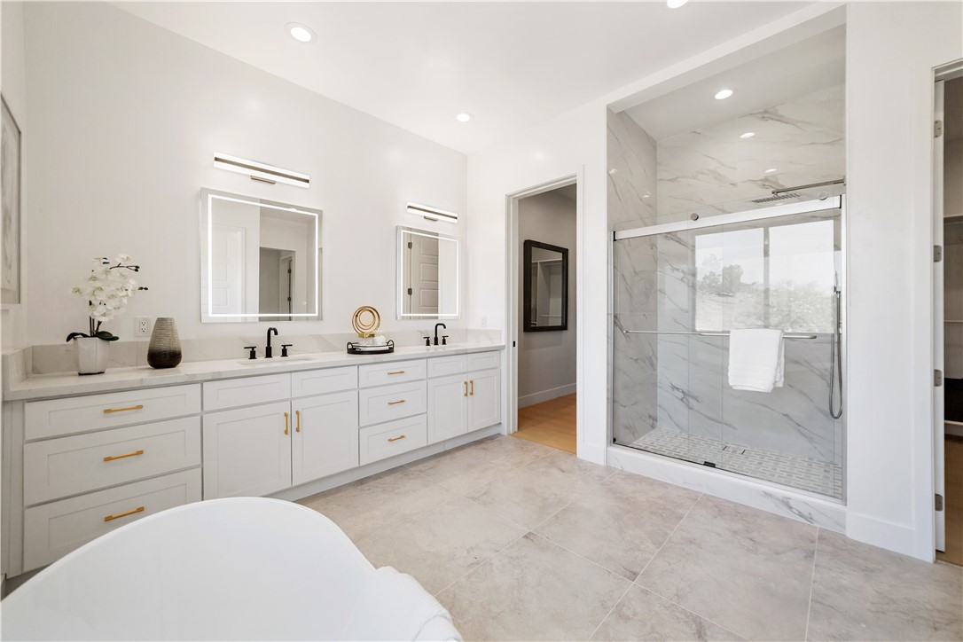 2027 Vía Monserate Fallbrook, CA 92028 - Photo 13 of 66 a spacious bathroom with a shower sink and mirror
