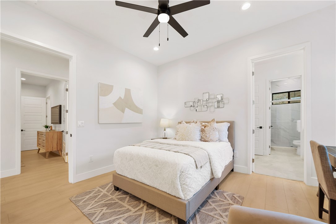 2027 Vía Monserate Fallbrook, CA 92028 - Photo 23 of 66 a bedroom with a bed and a chandelier