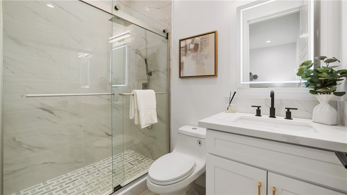 2027 Vía Monserate Fallbrook, CA 92028 - Photo 28 of 66 a bathroom with a sink a toilet and shower