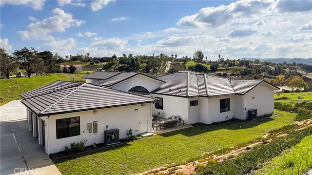 an aerial view of a house with a yard