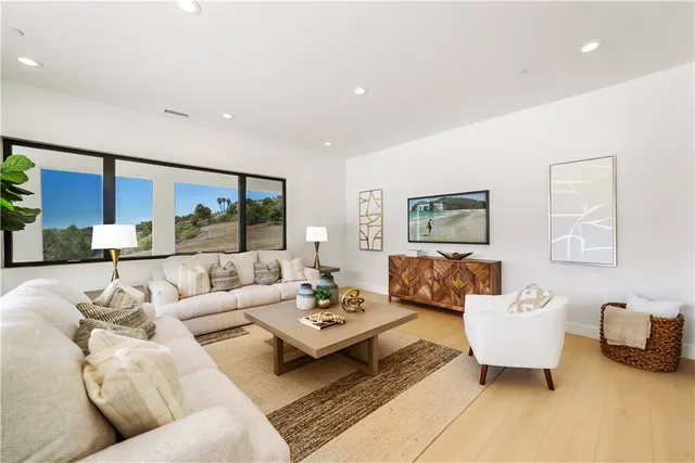 a living room with patio furniture and a potted plant