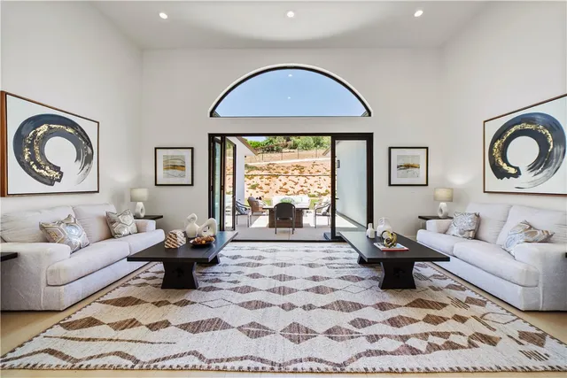 a dining room with a wooden table and chairs